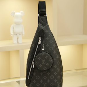 This shoulder bag combines Monogram canvas with Taïga calf leather, featuring a removable zippered pouch for coins or essentials and a zippered side pocket. It reinterprets versatile street style with a relaxed aesthetic, offering an alternative to traditional backpacks. Dimensions: 20 x 42 x 6 cm.